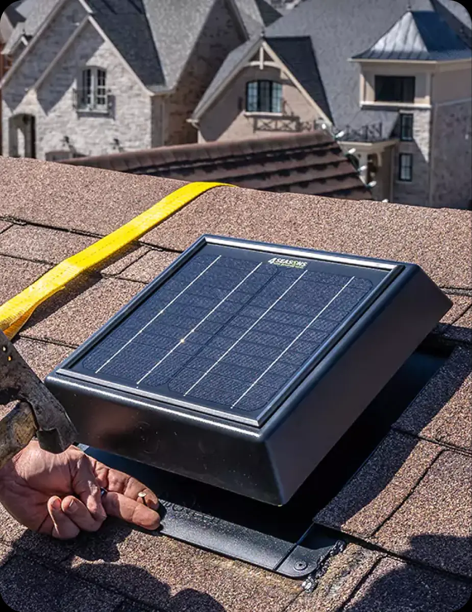 A 4SEASONS solar vent being installed on a shingled roof