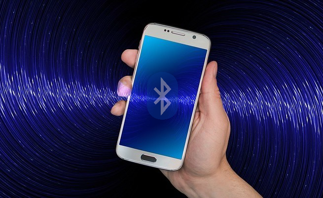 Illustrative image of a smartphone receiving Bluetooth waves.